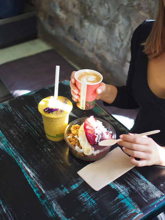 disposable coffee cups on a table with disposable cold cups and takeaway deli containers serving a healthy lunch