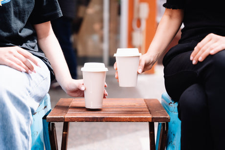 8oz and 12oz single wall coffee cups with compostable sugarcane lids on a table