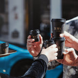 black single wall 4oz and 12oz custom branded coffee cups with matching lids in a group of friends hands