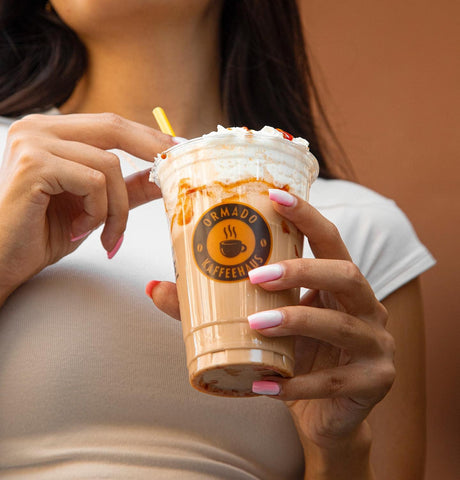 16oz custom printed disposable cup used to serve a iced coffee with cream