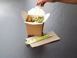 noodle box serving takeout stir fry eaten with chopsticks and a kraft paper napkin